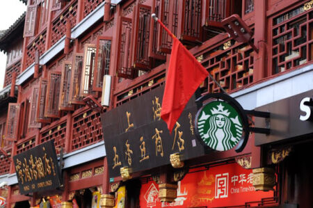 A Starbucks logo peeks out from a traditionally styled set of Chinese shopfronts.